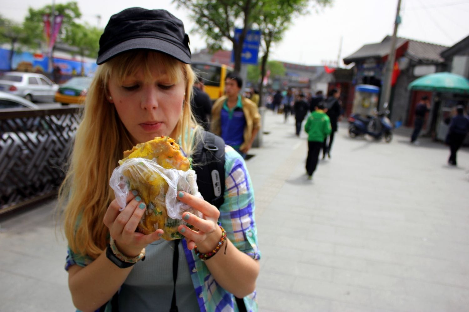 Agness eating Beijing street desserts