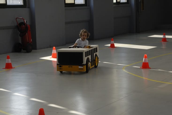 girl driving toy bus