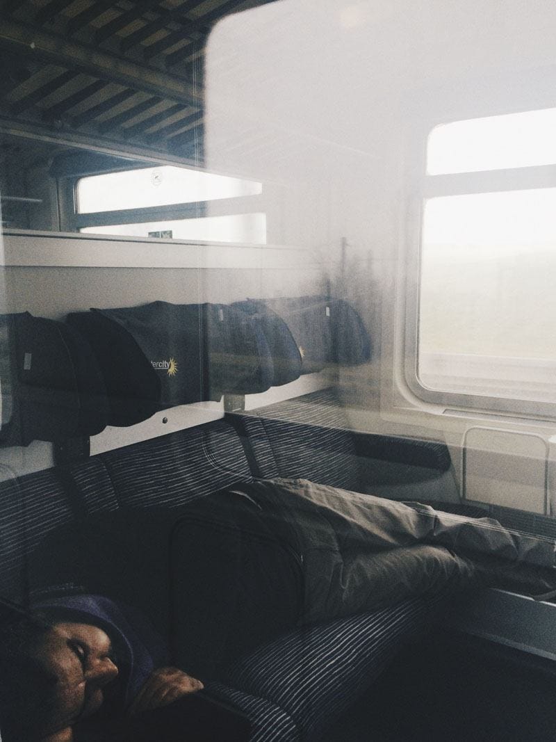 man sleeping on train italy