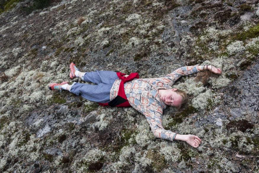girl lying on rocks