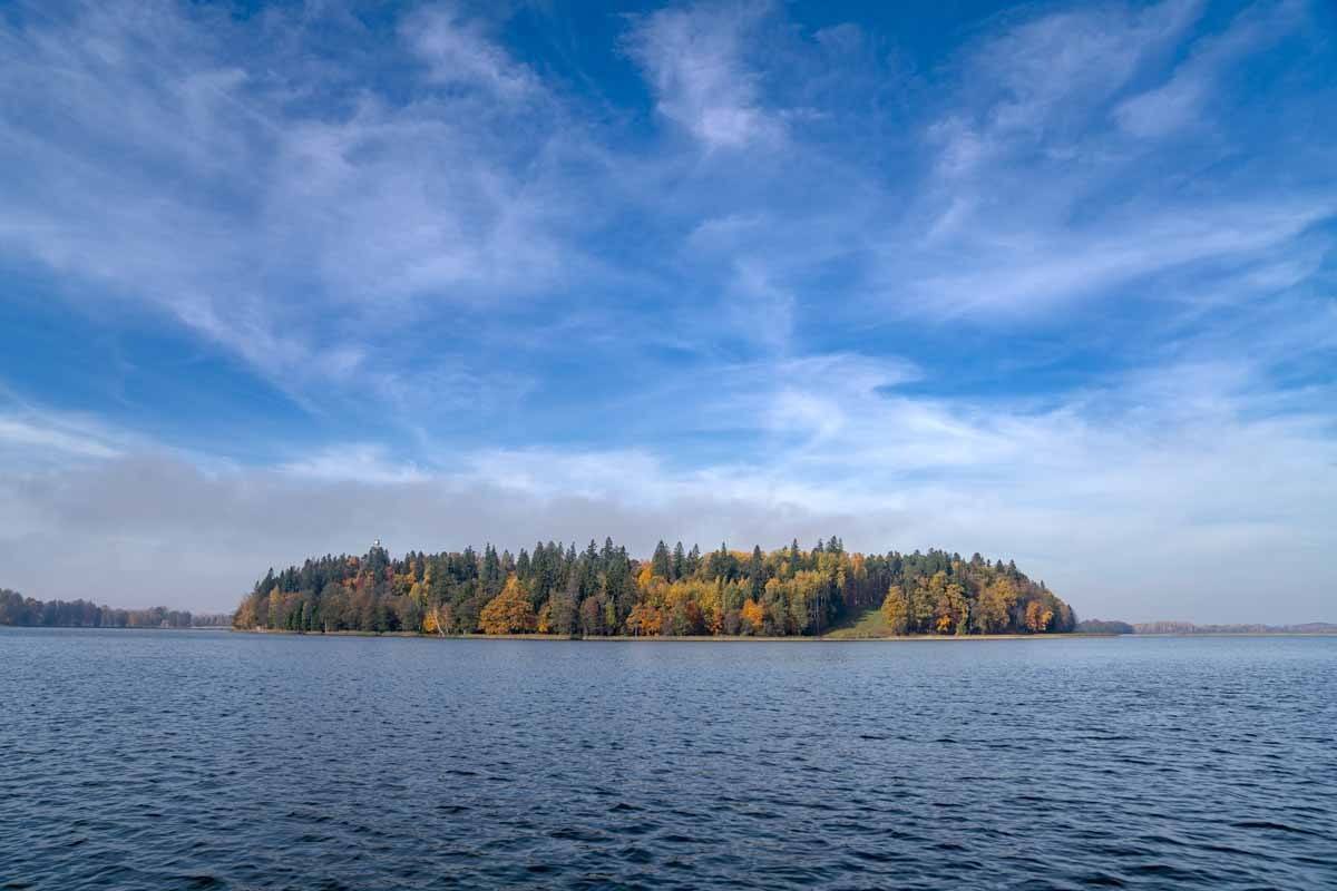 aluksne lake island blue sky