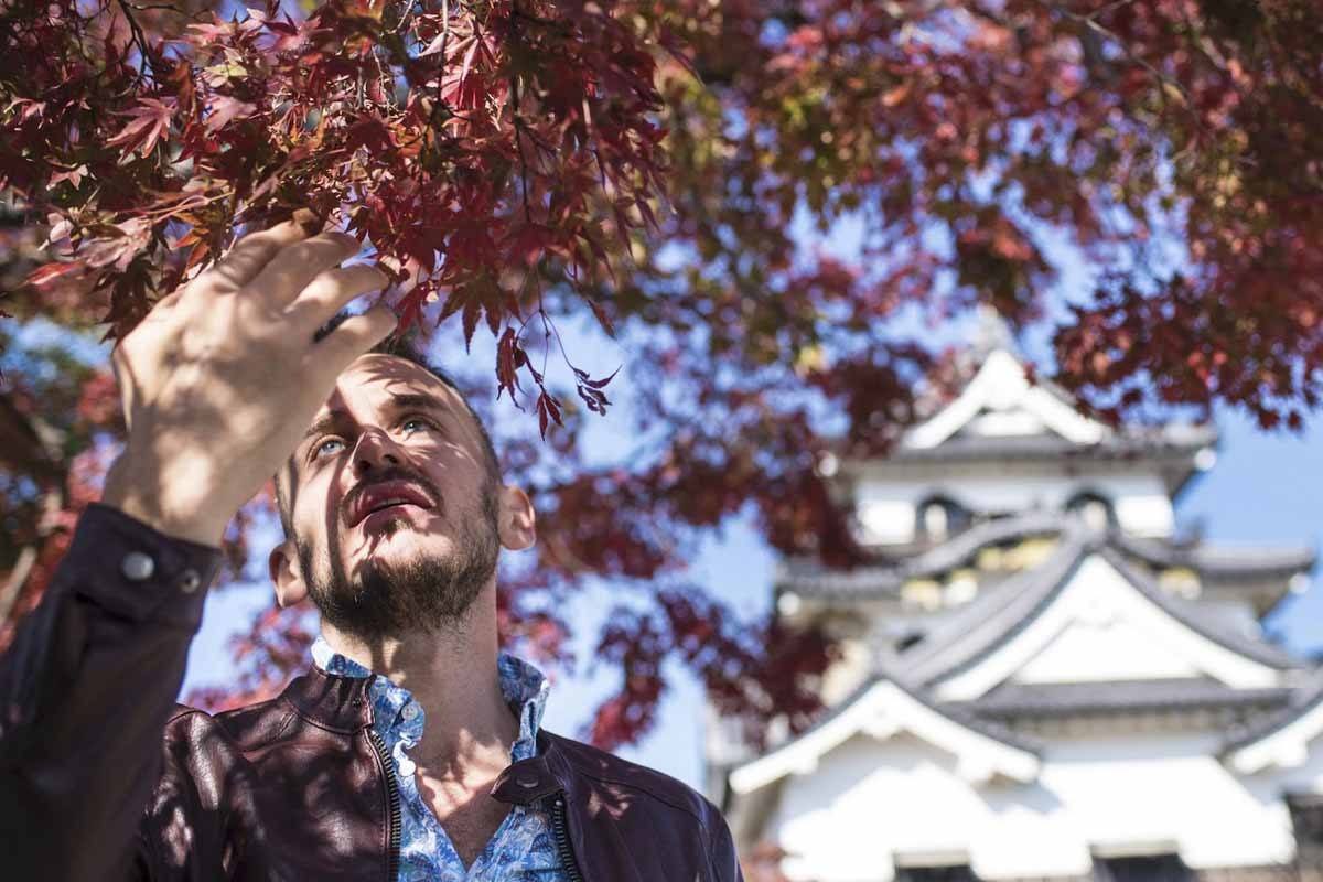 man at hikone castle with flowers