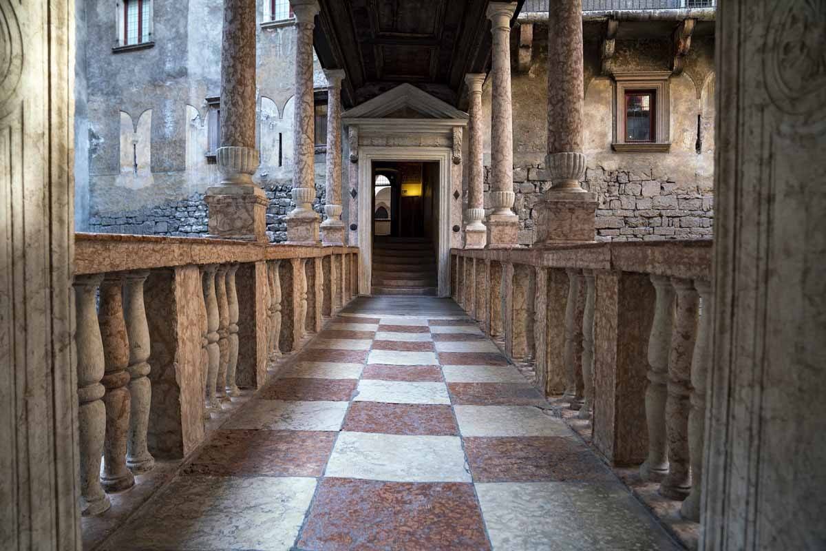 A corridor in Buonconsiglio Castle, columns and checked floor