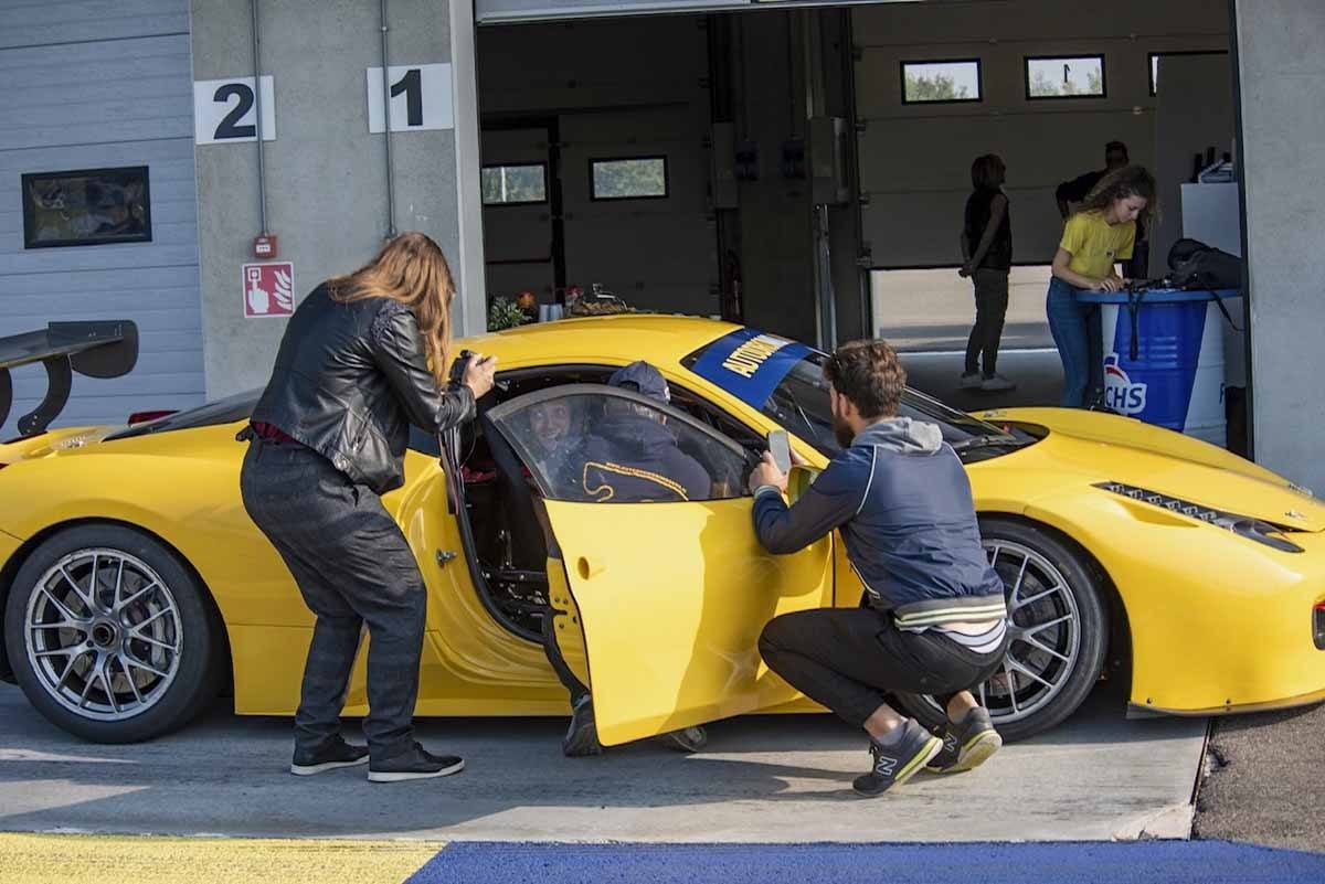 yellow ferrari with people